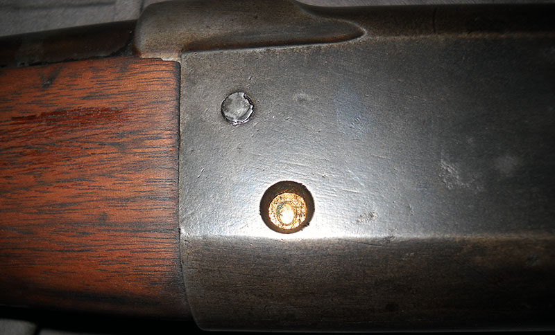 extreme close-up of the cartridge counter on a Savage 99, showing 0 rounds